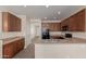 Well-lit kitchen features wooden cabinetry, stainless steel sink, and tiled flooring at 10287 S 175Th Ave, Goodyear, AZ 85338