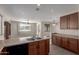 Bright kitchen features wooden cabinetry, stainless steel sink, and tile flooring at 10287 S 175Th Ave, Goodyear, AZ 85338