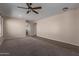 Bright and airy living room with neutral walls, carpet, and a ceiling fan at 10287 S 175Th Ave, Goodyear, AZ 85338