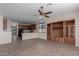Open-concept living space with tile floors, modern kitchen, and a built-in entertainment center at 10287 S 175Th Ave, Goodyear, AZ 85338