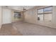 Large living room featuring carpet flooring, lots of windows, and a ceiling fan at 10287 S 175Th Ave, Goodyear, AZ 85338