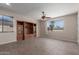 Spacious living room with tile floors, built-in shelving, and abundant natural light at 10287 S 175Th Ave, Goodyear, AZ 85338
