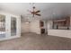 Open concept living room with tile flooring connecting to the kitchen, and backyard access at 10287 S 175Th Ave, Goodyear, AZ 85338