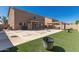 Backyard with artificial turf, a patio area, and a grill, perfect for outdoor entertaining at 11872 W Sherman St, Avondale, AZ 85323