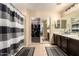 Bright bathroom featuring tile flooring, a sliding glass door shower, and a large mirror at 11872 W Sherman St, Avondale, AZ 85323