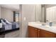Bathroom showing a sink with wooden cabinets and a bedroom in the background at 11872 W Sherman St, Avondale, AZ 85323