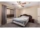 Bedroom featuring a queen bed, a window, and neutral walls at 11872 W Sherman St, Avondale, AZ 85323