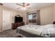 Neutral colored bedroom with a dresser and a window with natural lighting at 11872 W Sherman St, Avondale, AZ 85323