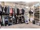 Walk-in closet featuring shelving units, clothing rods, and ample storage space at 11872 W Sherman St, Avondale, AZ 85323