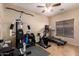 A home exercise room featuring an exercise machine, stationary bike, and treadmill at 11872 W Sherman St, Avondale, AZ 85323
