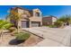 Attractive house featuring a three-car garage, a well-maintained lawn, and desert landscaping at 11872 W Sherman St, Avondale, AZ 85323