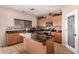 Well-lit kitchen with wooden cabinets, granite countertops, an island, and a convenient pantry at 11872 W Sherman St, Avondale, AZ 85323