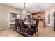 Kitchen area features a dining table, granite countertops, and stainless steel appliances at 11872 W Sherman St, Avondale, AZ 85323