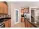 Kitchen features granite counters, stainless appliances, light wood cabinets, and a pantry door at 11872 W Sherman St, Avondale, AZ 85323