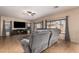 Spacious living room featuring a gray sofa, media center, neutral decor, and tile floors at 11872 W Sherman St, Avondale, AZ 85323