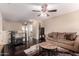 Cozy living room with dark wood floors, a plush rug, wet bar, and comfortable seating at 11872 W Sherman St, Avondale, AZ 85323