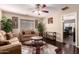 Comfortable living room with hardwood floors, two sofas, and access to other rooms in the house at 11872 W Sherman St, Avondale, AZ 85323