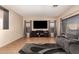 Living room featuring a media center with TV, cozy gray sofa, and a modern area rug at 11872 W Sherman St, Avondale, AZ 85323