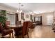 Open-concept living area with a dining table set and comfortable seating, perfect for entertaining at 11872 W Sherman St, Avondale, AZ 85323