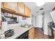 The well-maintained kitchen has a double sink, dishwasher and electric stove at 12123 W Bell Rd # 359, Surprise, AZ 85378