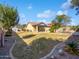 Spacious backyard with mature landscaping, covered patio, and view of the pool at 1227 E Indigo St, Gilbert, AZ 85298