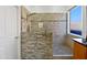 Modern bathroom features a spacious shower with stone accents and glass enclosure at 1227 E Indigo St, Gilbert, AZ 85298