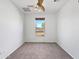 Cozy bedroom with neutral carpet and a large window overlooking the front yard at 1227 E Indigo St, Gilbert, AZ 85298