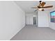 Bright bedroom with neutral carpet, ceiling fan, and a large window with backyard view at 1227 E Indigo St, Gilbert, AZ 85298