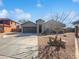 Charming single-story home featuring a spacious driveway and desert landscaping at 1227 E Indigo St, Gilbert, AZ 85298