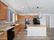 Modern kitchen boasts stainless appliances, granite counters, a large island and tile backsplash at 1227 E Indigo St, Gilbert, AZ 85298