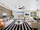 Bright living room with modern decor, a wood accent wall, and large windows providing natural light at 1227 E Indigo St, Gilbert, AZ 85298