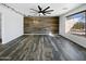 Spacious living room with wood-look floors, accent wall, modern lighting, and large window at 1227 E Indigo St, Gilbert, AZ 85298