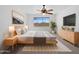 Cozy bedroom featuring a ceiling fan, a neutral color scheme, and a large window at 1227 E Indigo St, Gilbert, AZ 85298