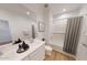Bathroom featuring double sinks, white cabinets, and a shower-tub combination at 12552 W Trumbull Rd, Avondale, AZ 85323