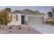 Charming single-story home featuring neutral tones, well-kept landscaping, and an attached two-car garage at 12552 W Trumbull Rd, Avondale, AZ 85323