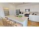 Bright kitchen features an island with bar seating, stainless steel appliances, and white cabinets at 12552 W Trumbull Rd, Avondale, AZ 85323