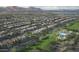 Expansive aerial view of the community showcasing neatly arranged houses and a vibrant green amenity center at 12556 W Trumbull Rd, Avondale, AZ 85323