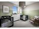 Delightful Bedroom with two cribs, soft colors, and charming decor at 12556 W Trumbull Rd, Avondale, AZ 85323