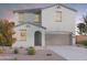 Charming two-story home with a neutral color scheme, a two-car garage, and desert landscaping at 12556 W Trumbull Rd, Avondale, AZ 85323