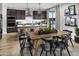 Modern kitchen features a stylish island, dark cabinets, pendant lights, and stainless steel appliances at 12556 W Trumbull Rd, Avondale, AZ 85323