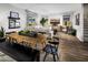 Open-concept living area with a dining area, wood flooring, and abundant natural light at 12556 W Trumbull Rd, Avondale, AZ 85323