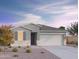 Charming single-story home with a neutral color scheme, stone accents, desert landscaping, and a two-car garage at 12564 W Trumbull Rd, Avondale, AZ 85392