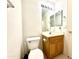 Cozy bathroom featuring a toilet, sink, vanity, mirror, and lighting fixture for a functional space at 13253 W Lisbon Ln, Surprise, AZ 85379