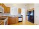 Functional kitchen featuring wood cabinets, tile countertops, and modern appliances at 13253 W Lisbon Ln, Surprise, AZ 85379