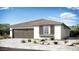 A charming single-story home with neutral colors, complemented by a well-maintained front yard and a two-car garage at 14493 W Sand Hills Rd, Surprise, AZ 85387