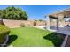 Expansive backyard with lawn, covered patio, refreshing pool, and privacy at 15412 N 160Th Ln, Surprise, AZ 85374