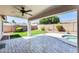 Relaxing covered patio, lush lawn, and privacy fencing enhance this yard's appeal at 15412 N 160Th Ln, Surprise, AZ 85374