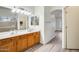 Bathroom with double vanity, wood cabinets, and a walk-in shower at 15412 N 160Th Ln, Surprise, AZ 85374