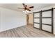 Bedroom showcasing wood-look flooring, white walls, and decorative sliding barn doors at 15412 N 160Th Ln, Surprise, AZ 85374