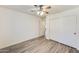 Bedroom featuring laminate floors, a ceiling fan, closet and access to an adjoining space at 15412 N 160Th Ln, Surprise, AZ 85374